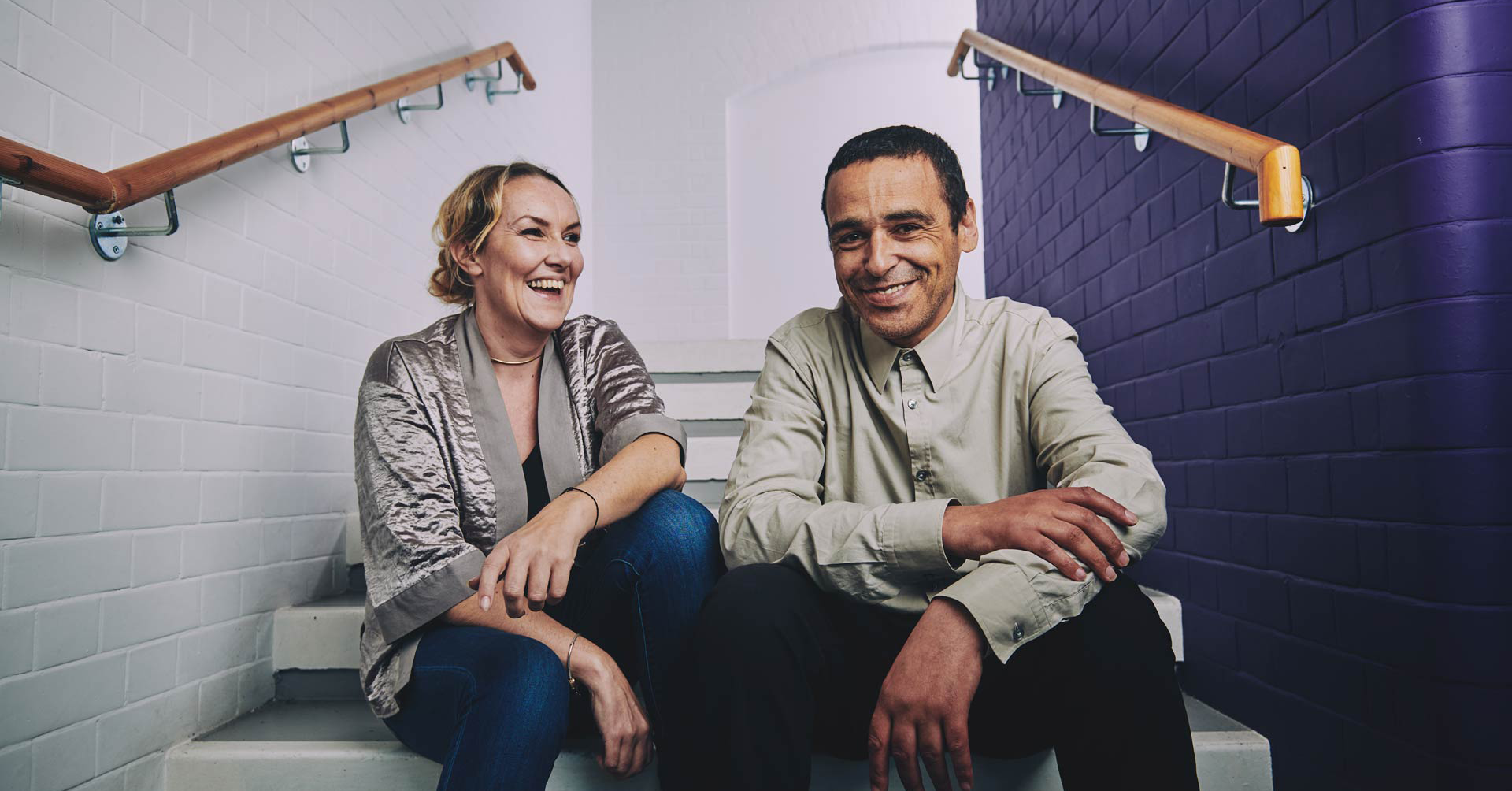 two people sitting on the stairs smiling