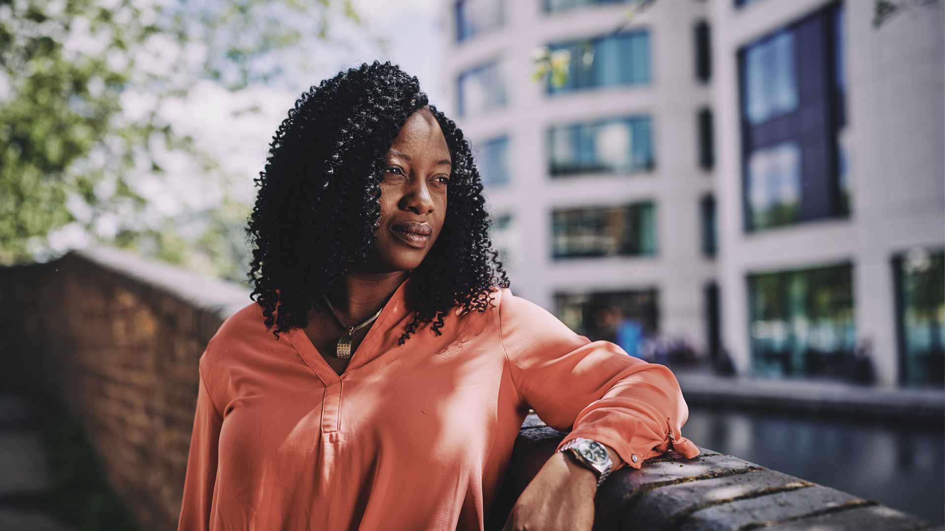 woman standing on a bridge looking into the distance