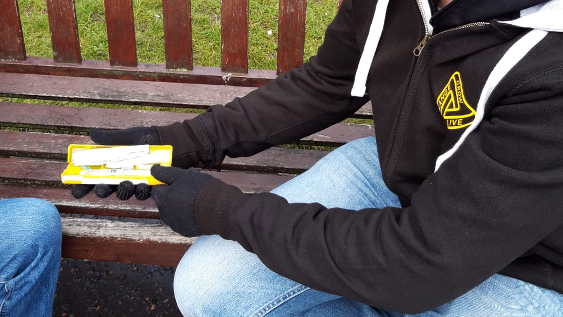 A man showing someone a naloxone kit
