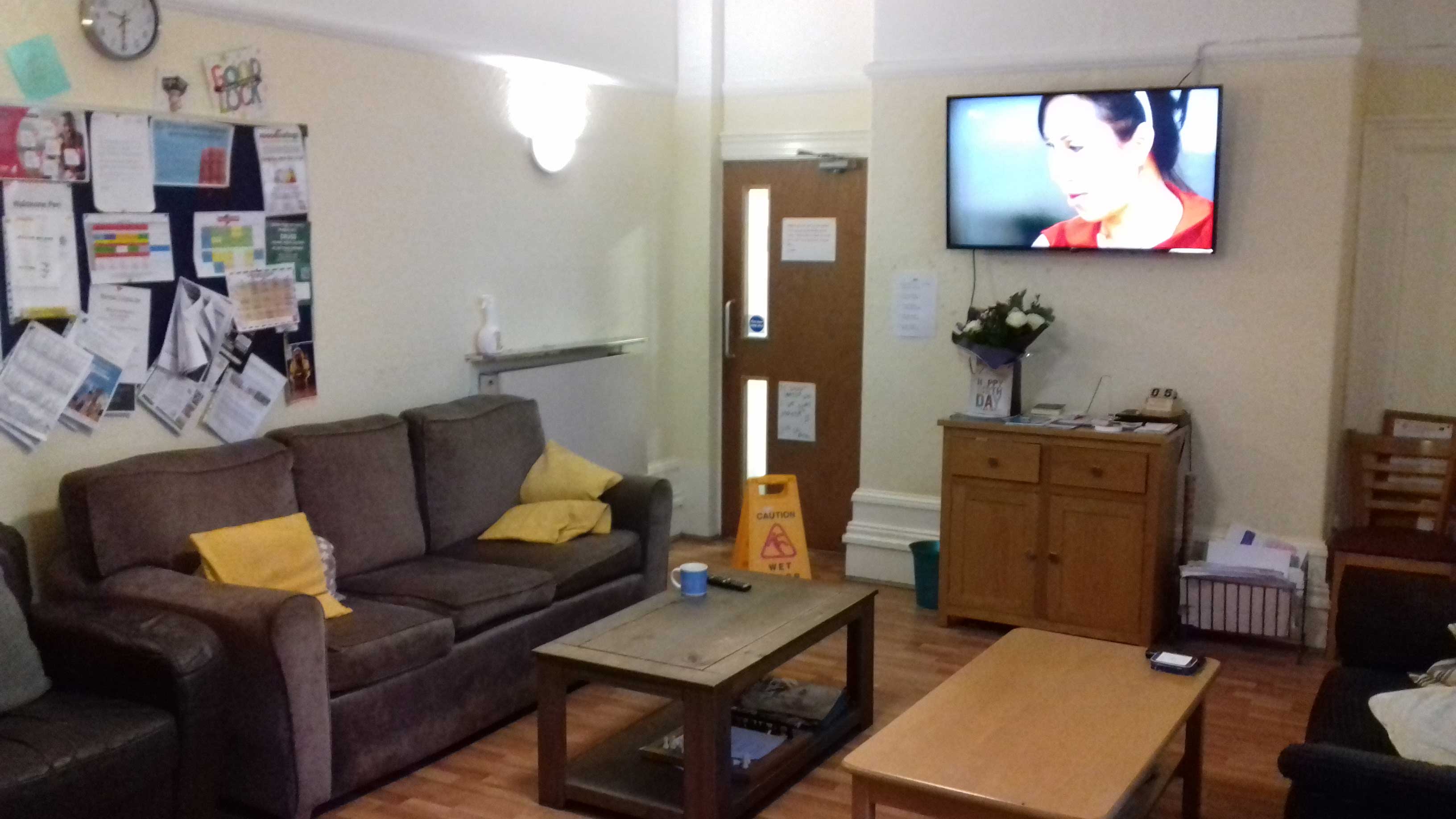 Leigh bank - communal room with sofa, notice board, coffee tables and at tv