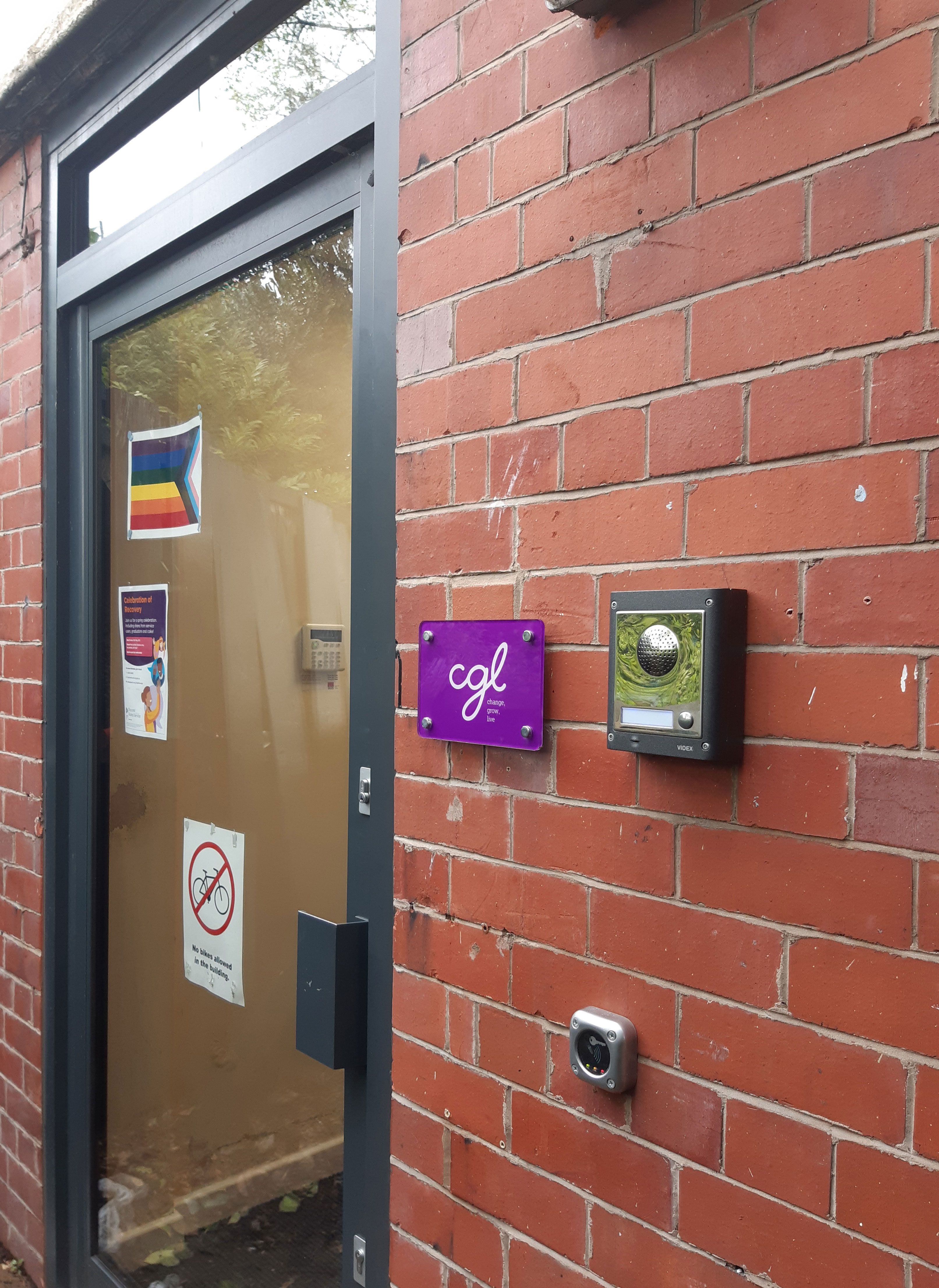 The front door of the Macclesfield service - a red brick building. Buzzer on the right.