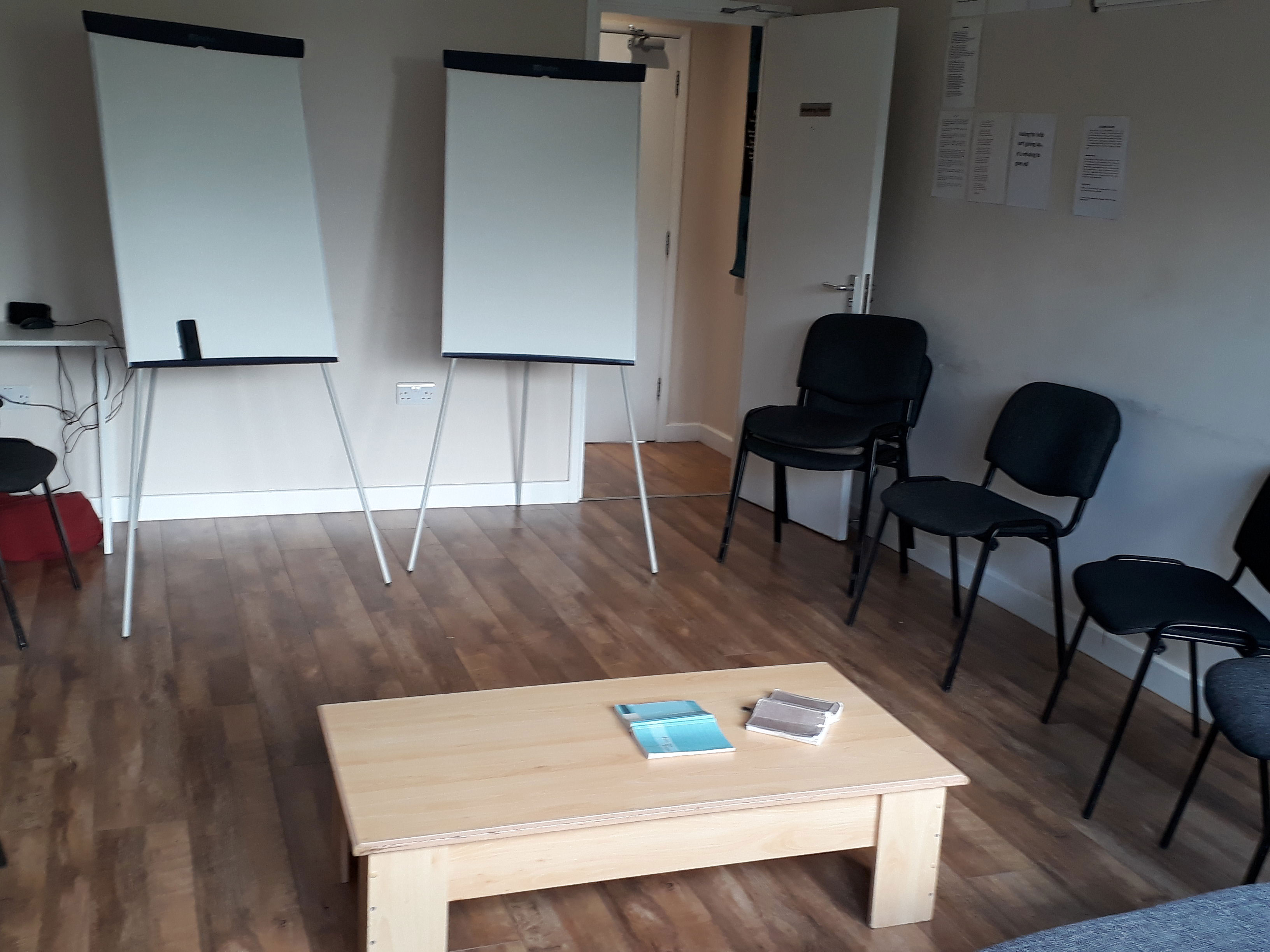 ESH group room - a room with flip chards, chairs in a 'u' shape and a coffee table.