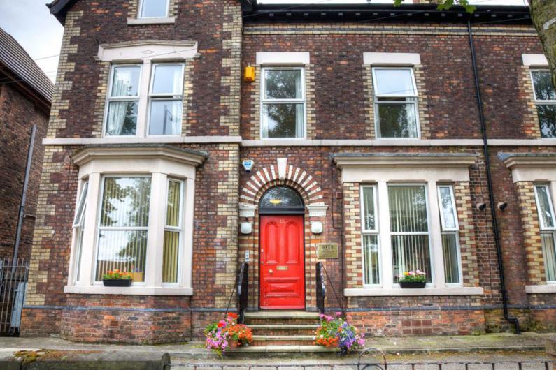 Birchwood residential outside - A large building with sash windows and red front door