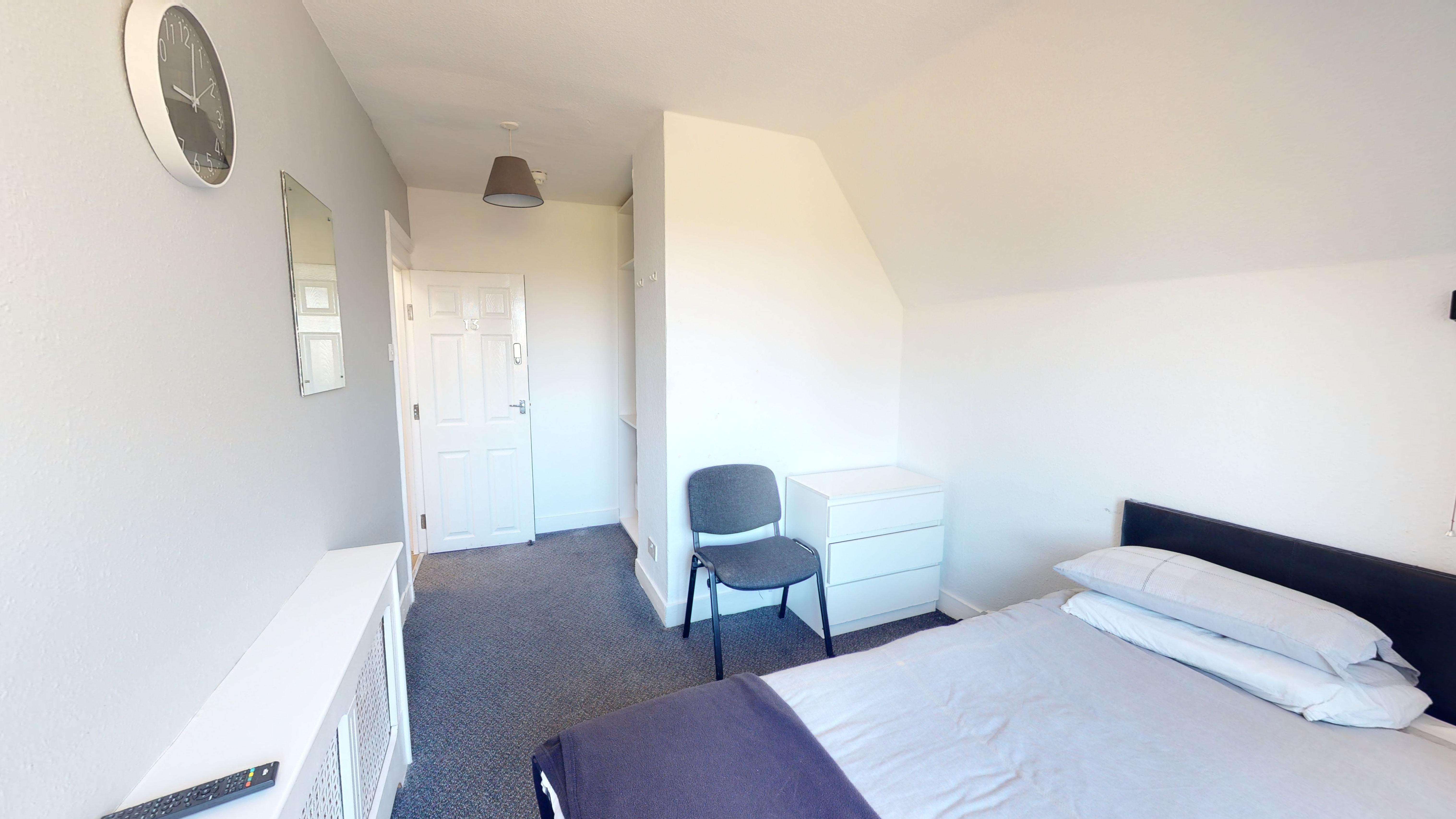 Liberty House Bedroom. - A room with a singe bed, white walls and grey carpet.