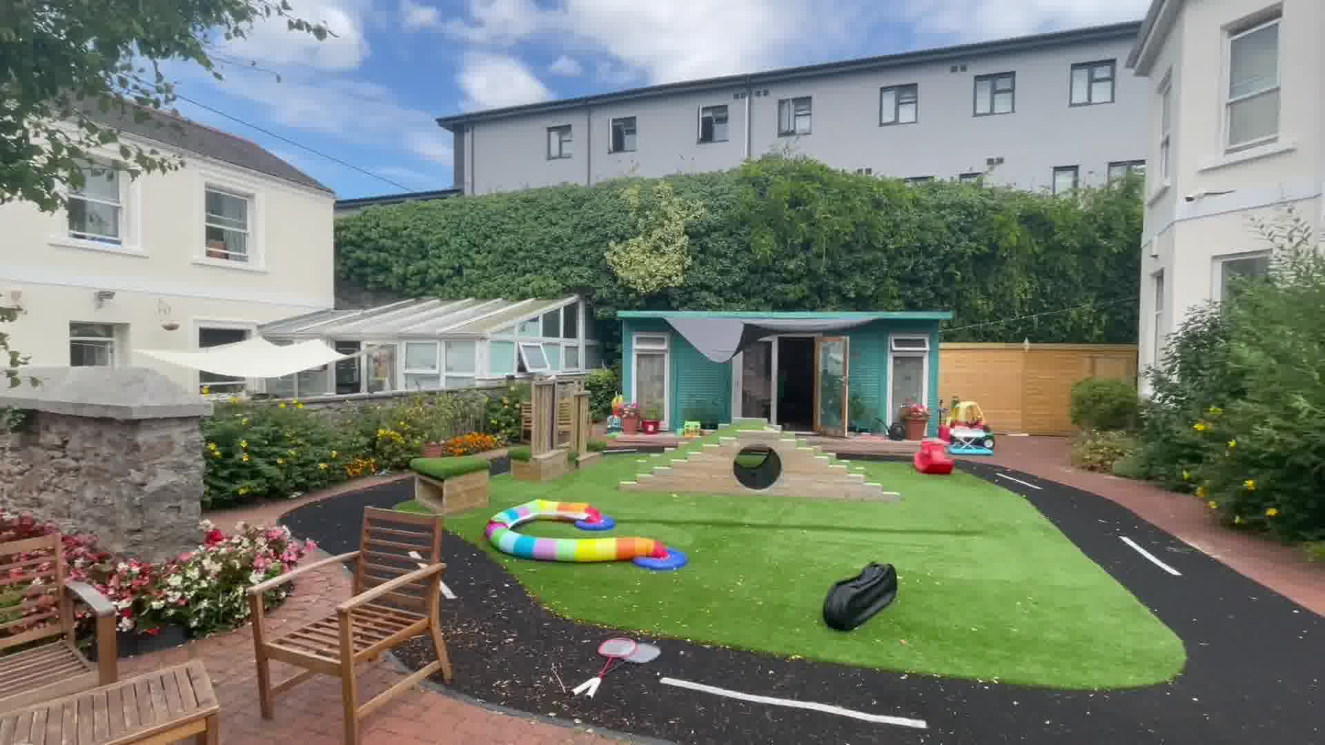 A garden that has children's toys scattered around