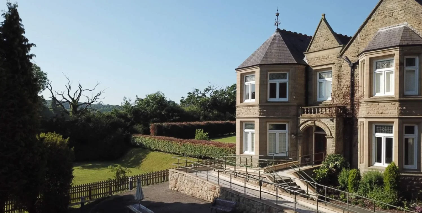 An old Victorian mansion with a sprawling garden