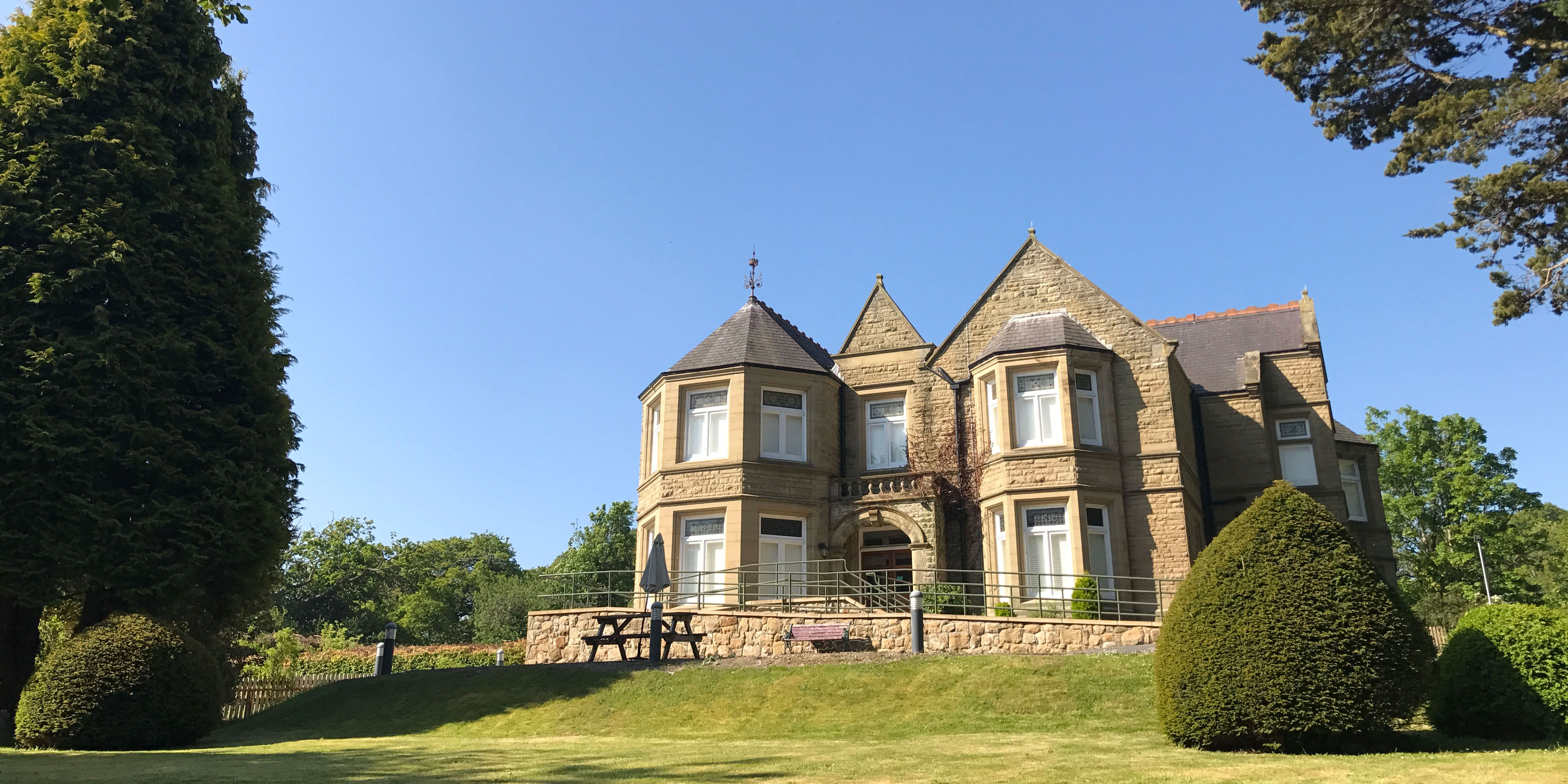 An old Victorian mansion with a sprawling garden