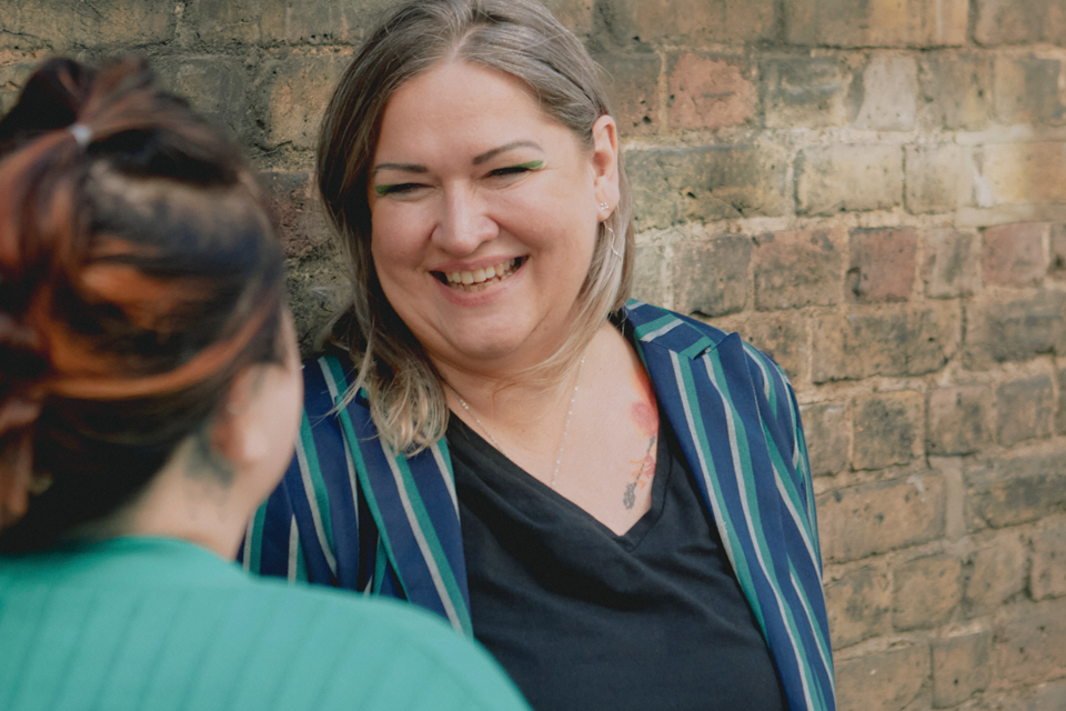 Aldona smiles and chats to a colleague