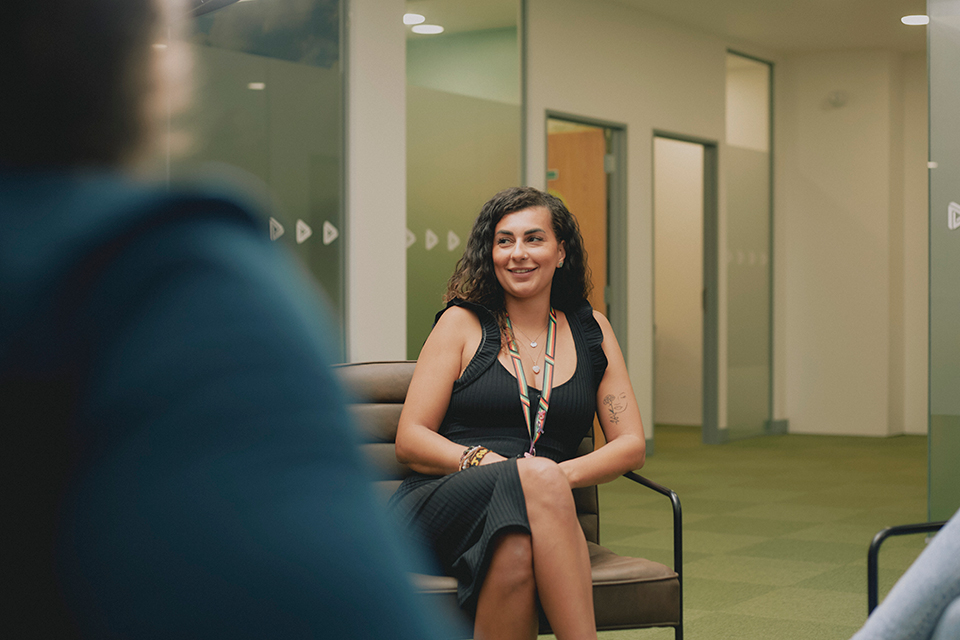 Chantelle sitting talking to a colleague at a Change Grow Live service