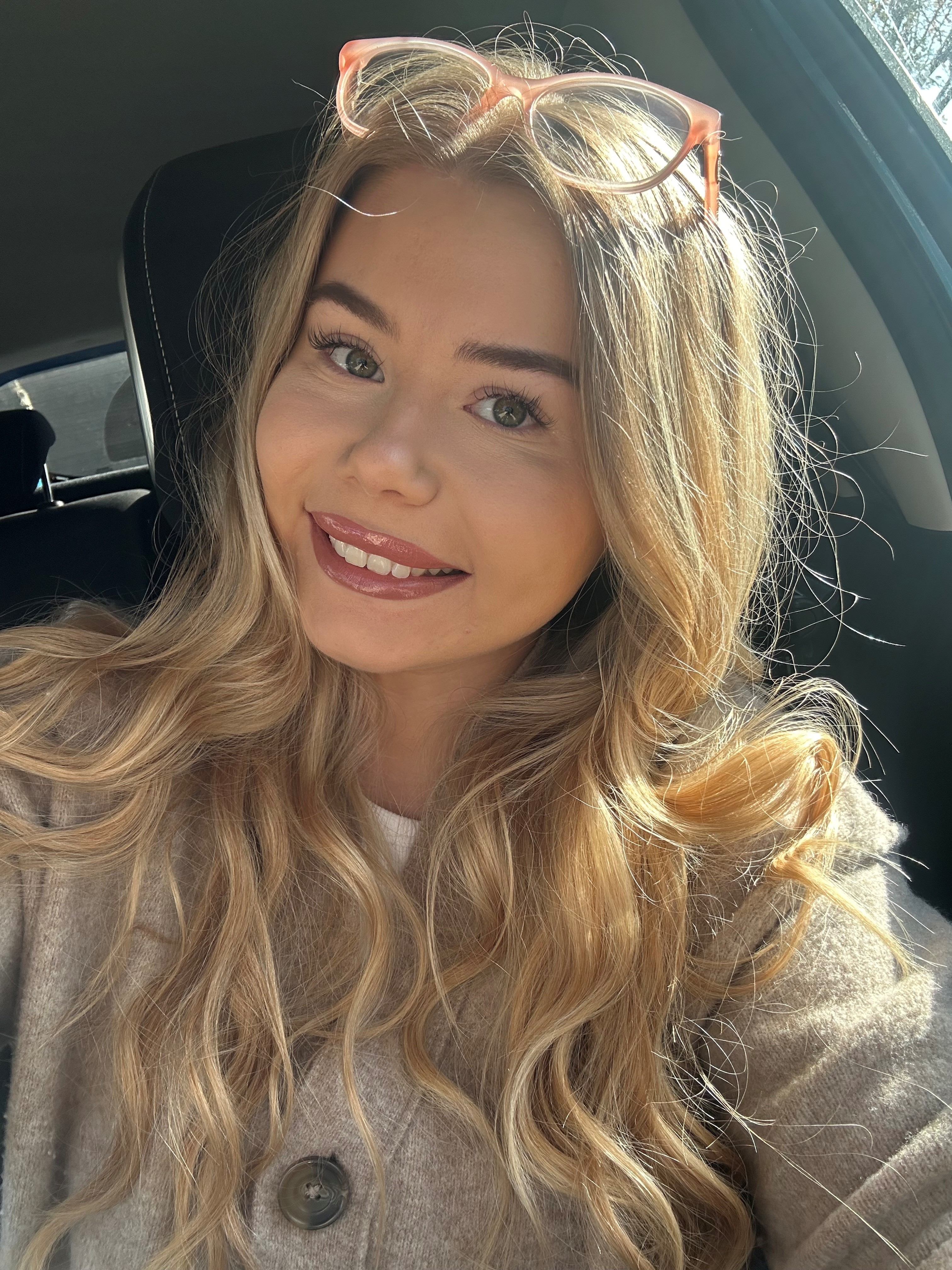 Megan has long blonde hair and is smiling