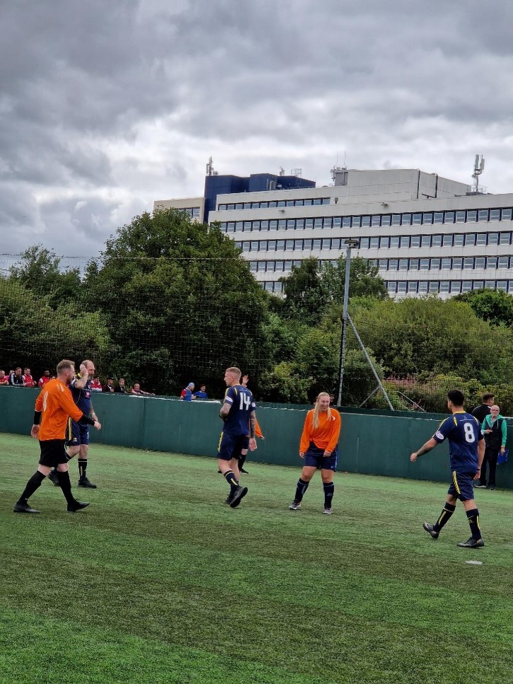 men playing football on a green pitch 