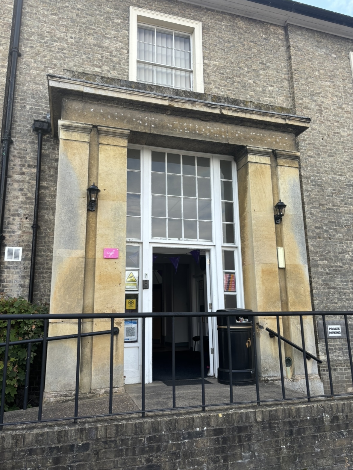 The outside of a building with a column entrance