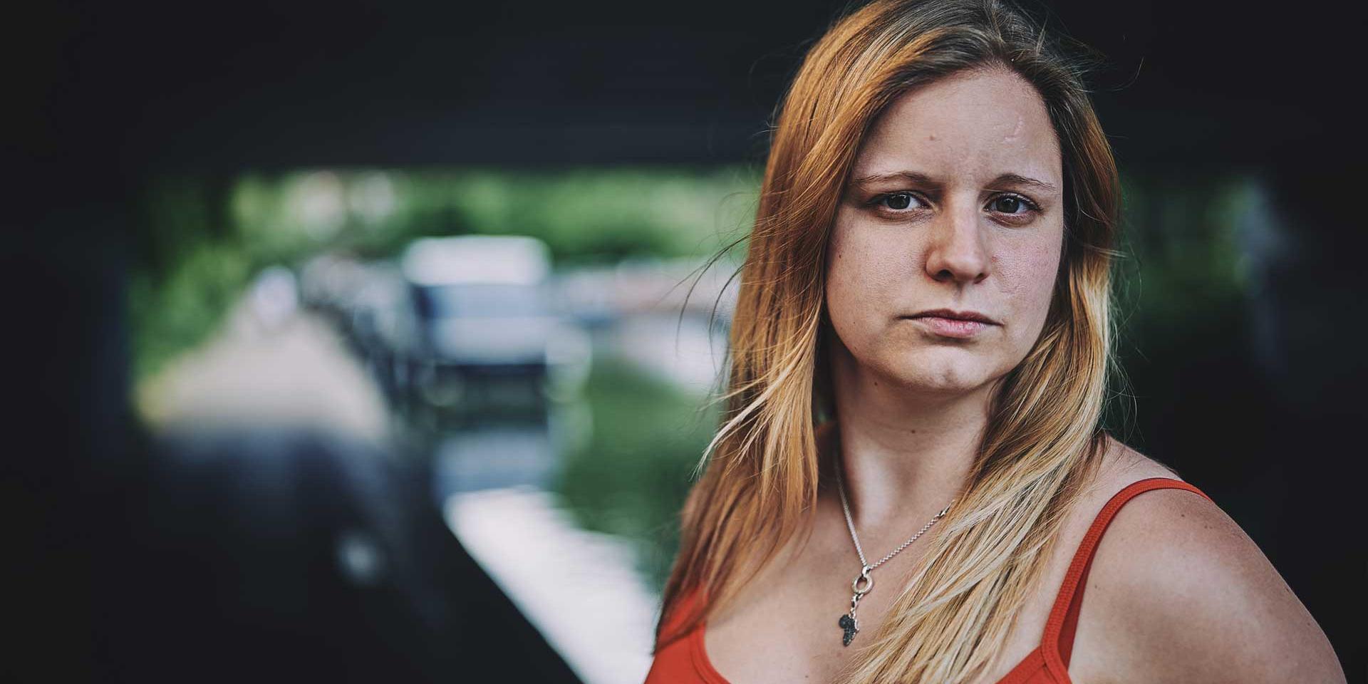 A woman standing in front of a canal