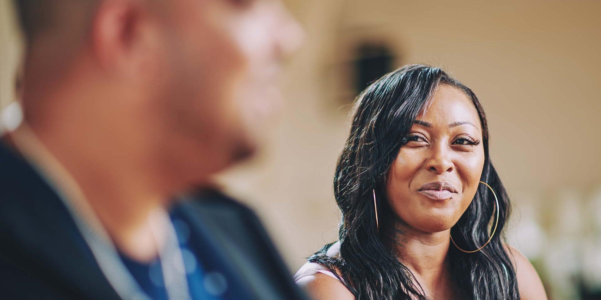 A woman is smiling at a man