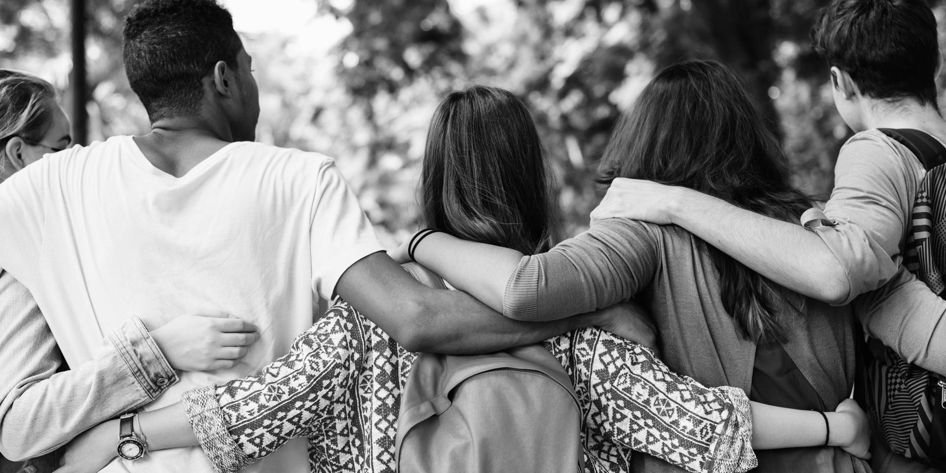 group of teenagers with their arms around one another