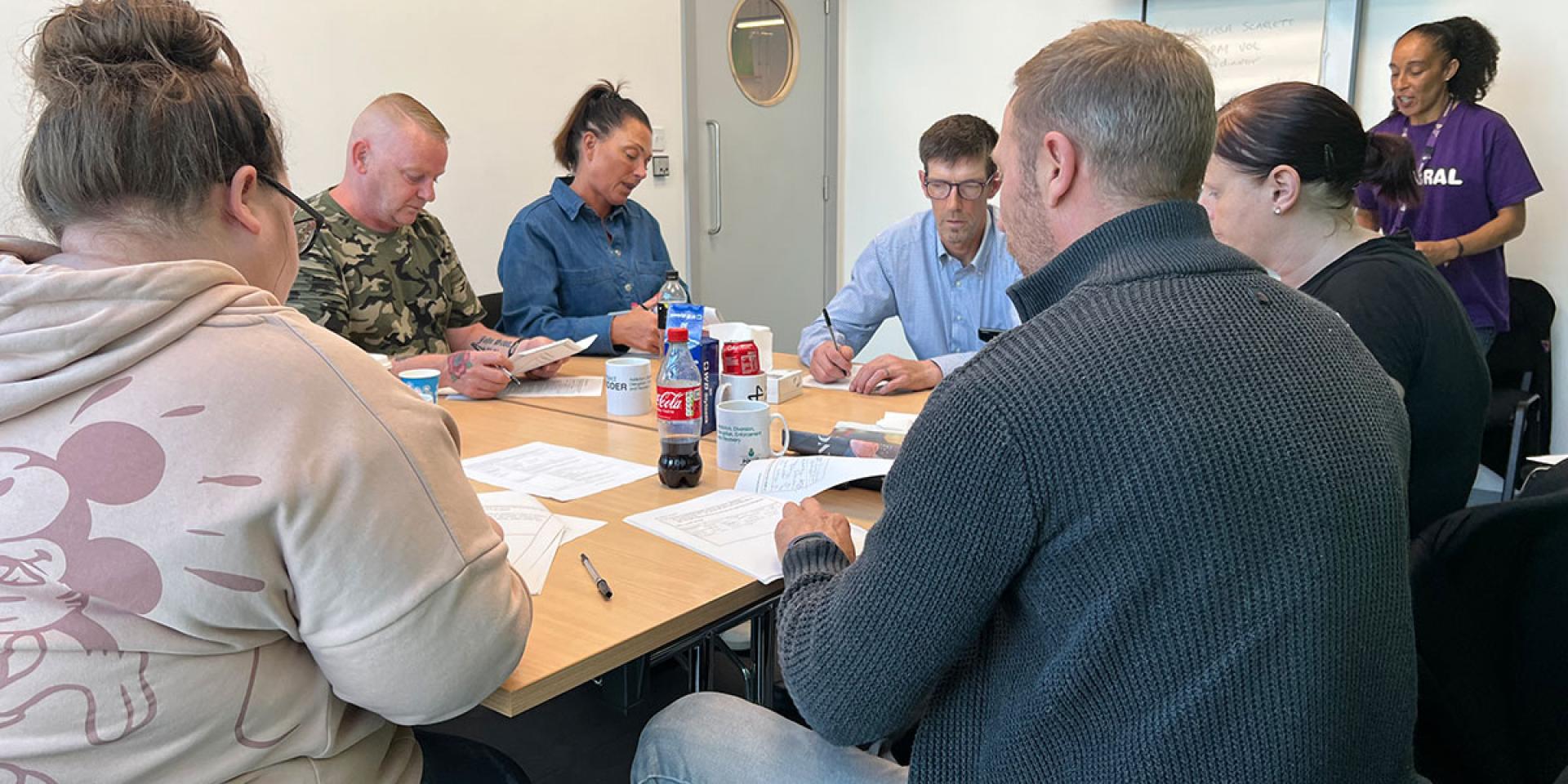 A group of people in a volunteer training session at Wirral Ways