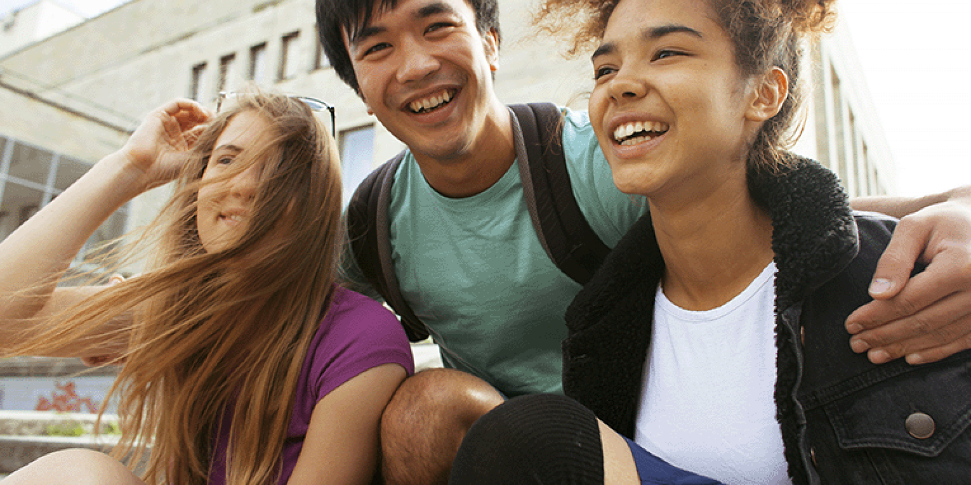 Trio of young people laughing