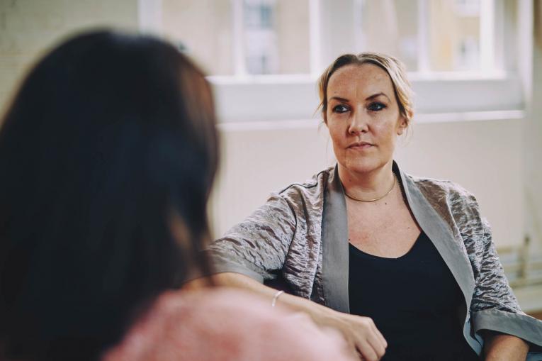 Two women are sitting having a conversation