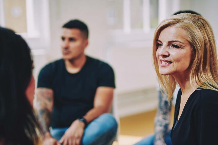 A woman is having a conversation in a group