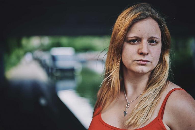 A woman standing in front of a canal