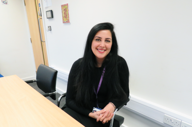 woman sitting at a table smiling