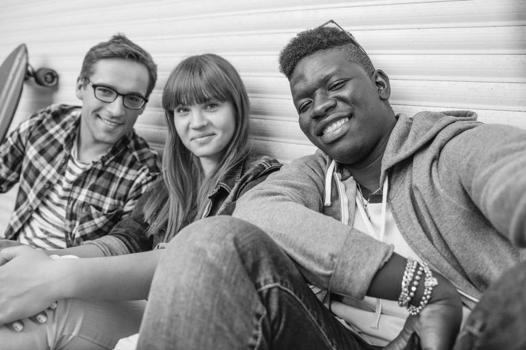 Three young people taking a group selfie