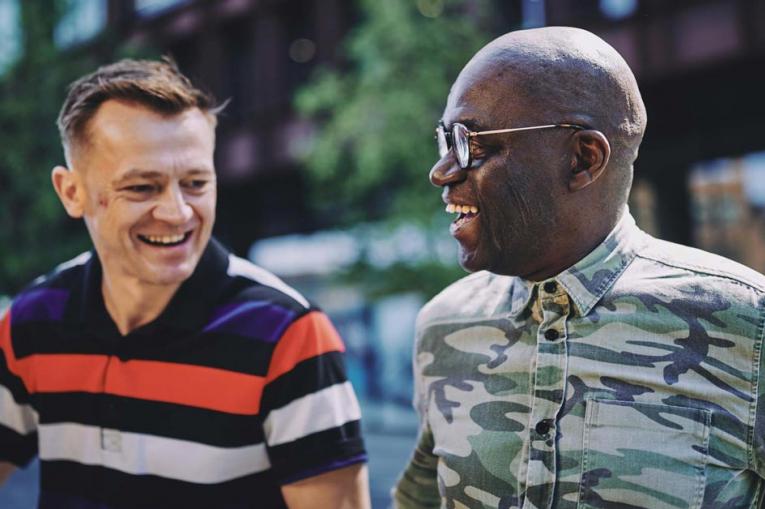 two people smiling and talking