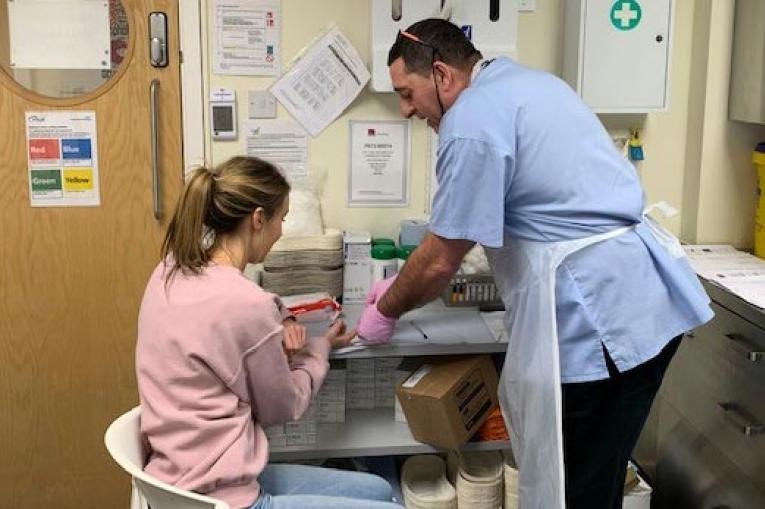 Photo shows a woman getting tested for hep C