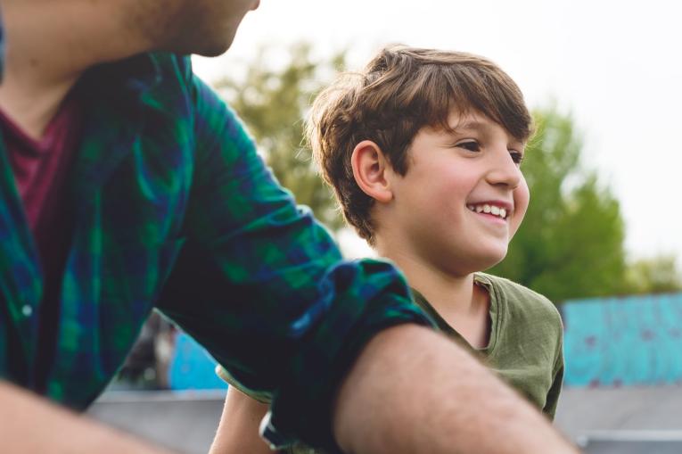 A boy and a man at a skatepark