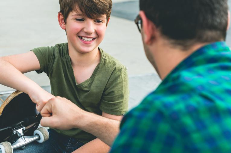 A man and a child at a skatepark