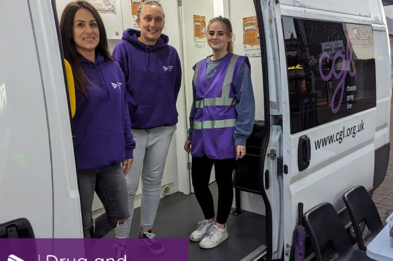 Kirklees night bus - three people standing inside the bus smiling at the camera