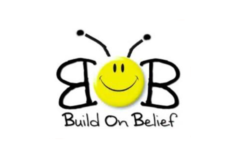 Build on Belief logo. Two B's make up butterfly wings and a yellow smiley face makes up the body. Antennae are coming out of the smiley face and the words Build on Belief are underneath the butterfly 