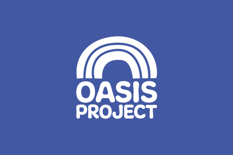 A blue background with a white rainbow and the words Oasis Project