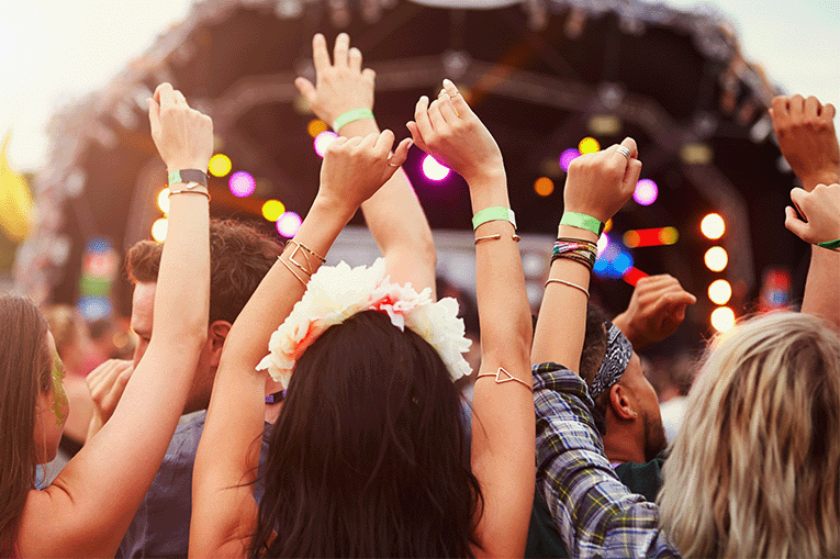 Image of a crowd at a festival watching a performance