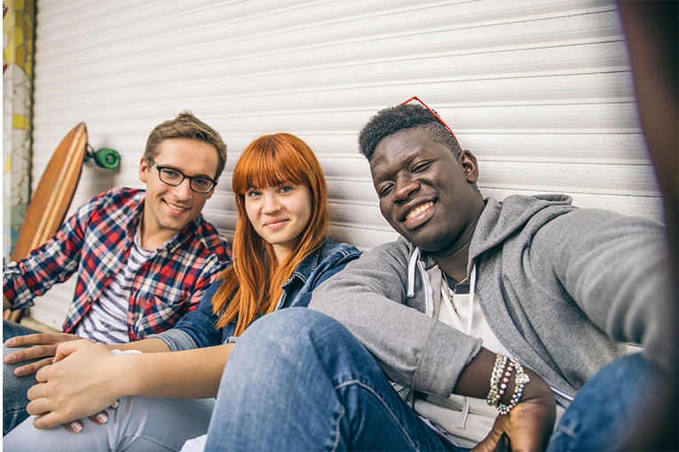 Three young people smiling for the camera