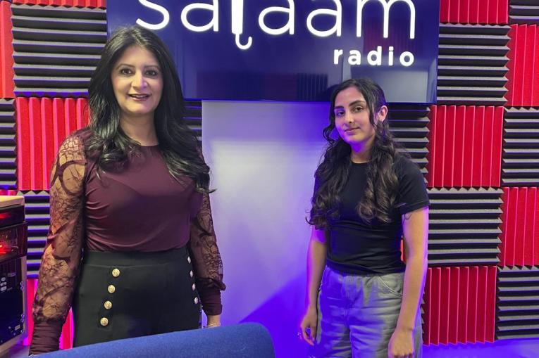 Dr Shabina and Aaliyah standing in front of a 'salaam radio' sign