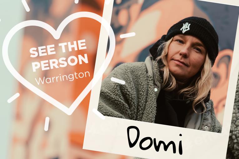 A colourful wall background with a heart stamp on the left with the words See The Person Warrington inside the heart. On the right is a polaroid photo with a young woman wearing a black beanie hat and grey fluffy coat. The name Domi is at the bottom of the polaroid.