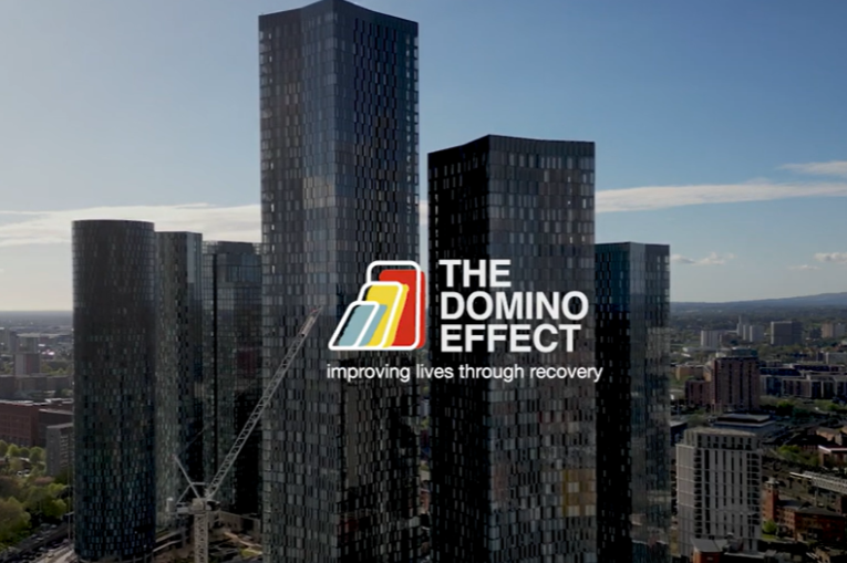 The Manchester Skyline with The Domino Effect logo