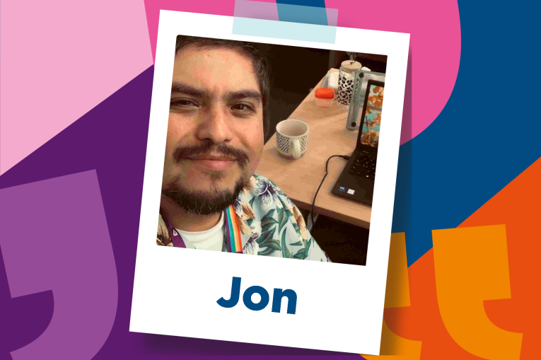 Jon is wearing a Hawaiian shirt and has a moustache and beard