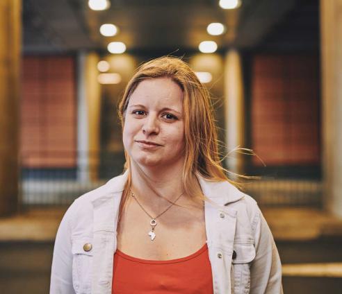 woman smiling under a bridge