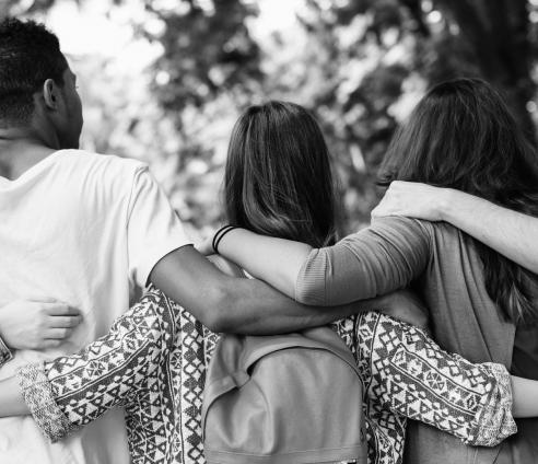 group of teenagers with their arms around one another