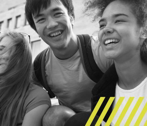 three teenagers smiling and laughing