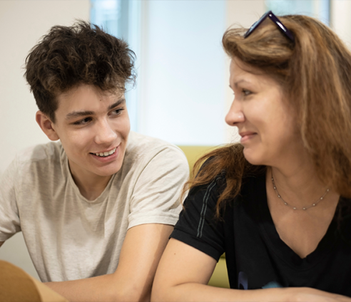 A teenager chats to a mentor in service