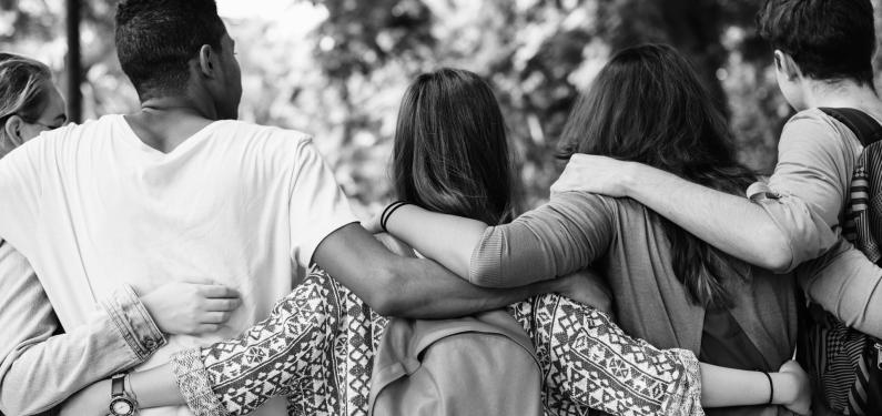 group of teenagers with their arms around one another