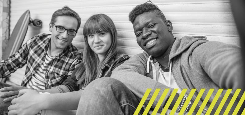 Three young people taking a group selfie