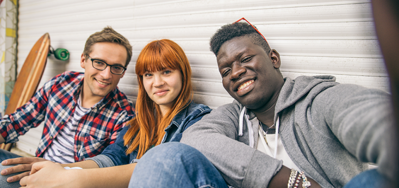 Three young people smiling at camera