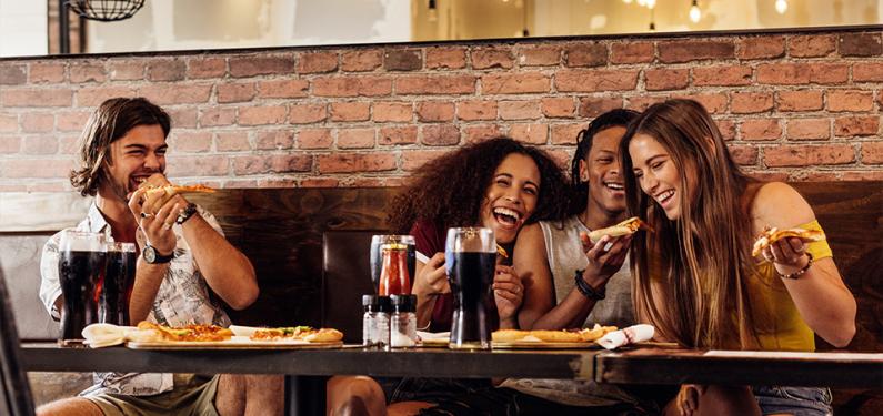 A group of friends eating together in a restaurant