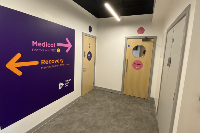 A hallway in the Wirral hub with signposts to different places in the service