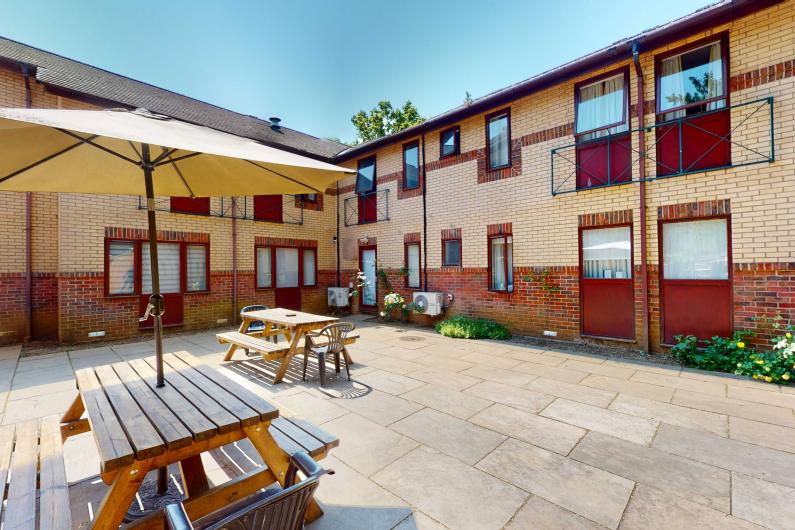 A courtyard area with picnic benches